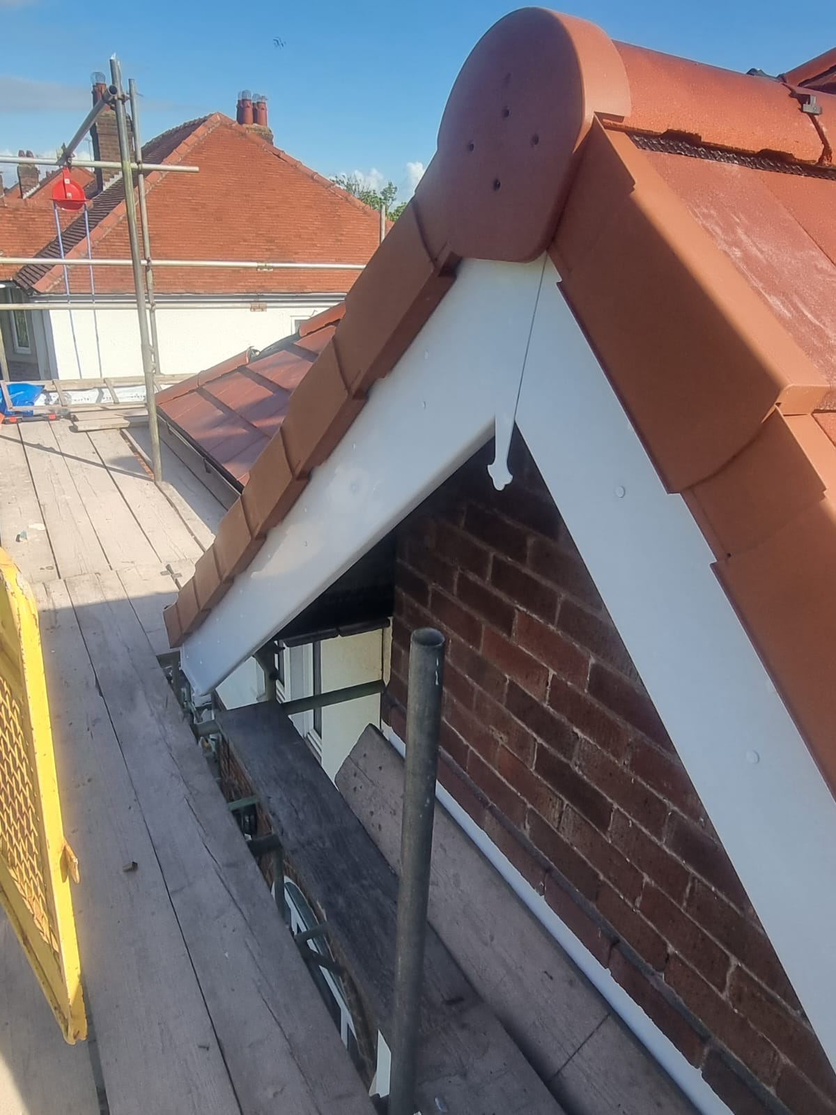 New clay ridge tiles & bonnet hip detail with fresh fascia and gutter