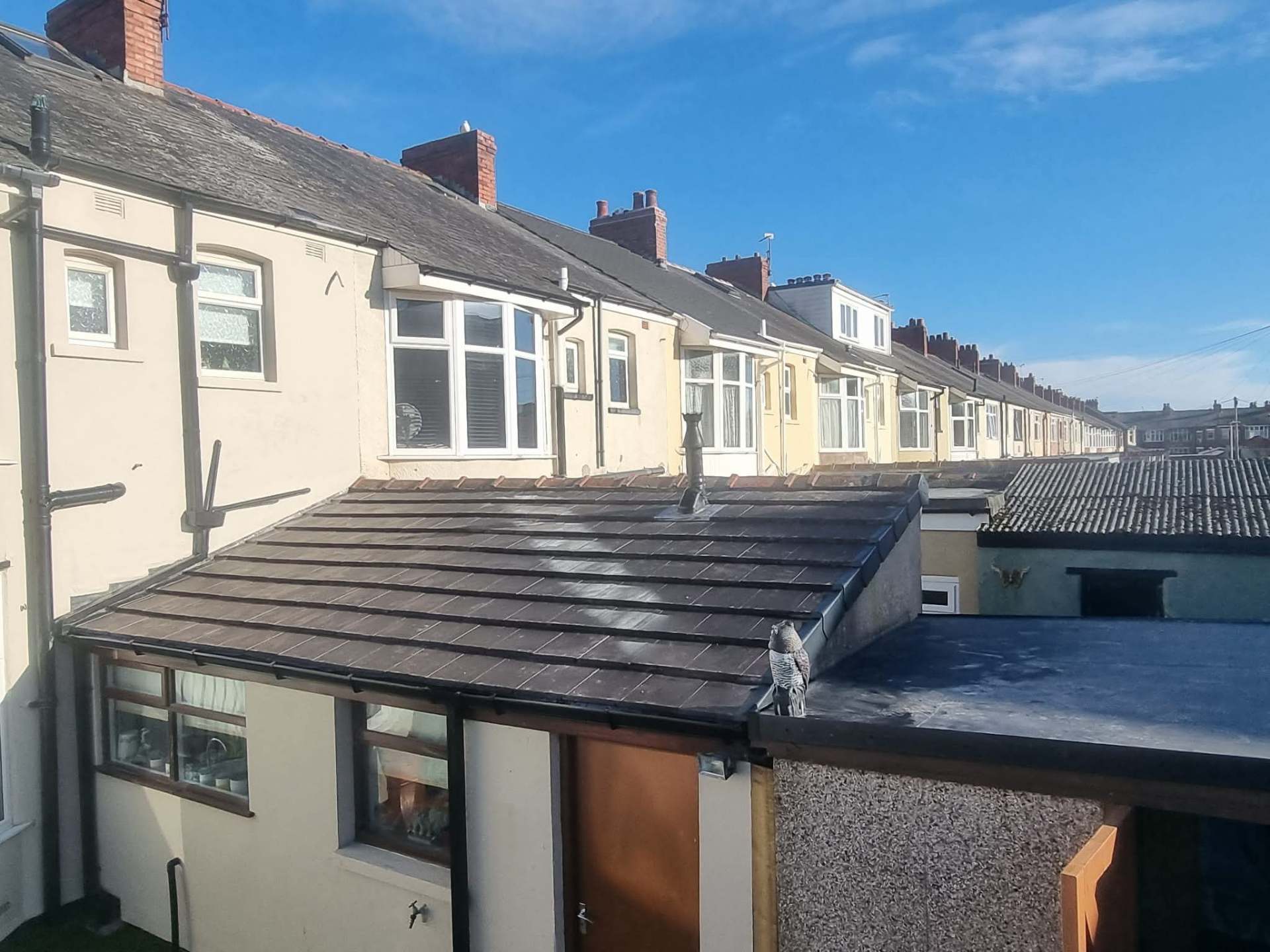 Full pitched roof replacement with new flat roof finish