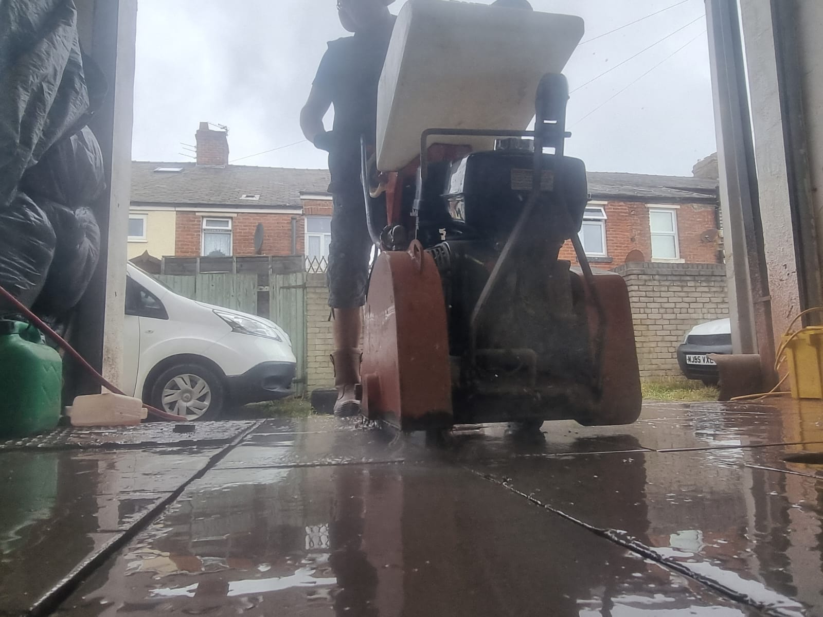 Floor saw cutting concrete in preparation for new drainage
