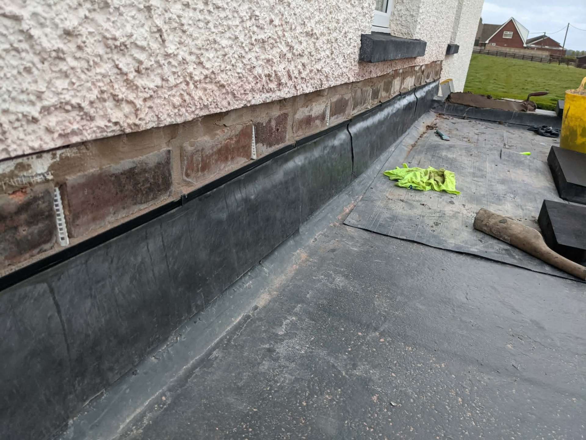 EPDM rubber flat roof with brick repairs