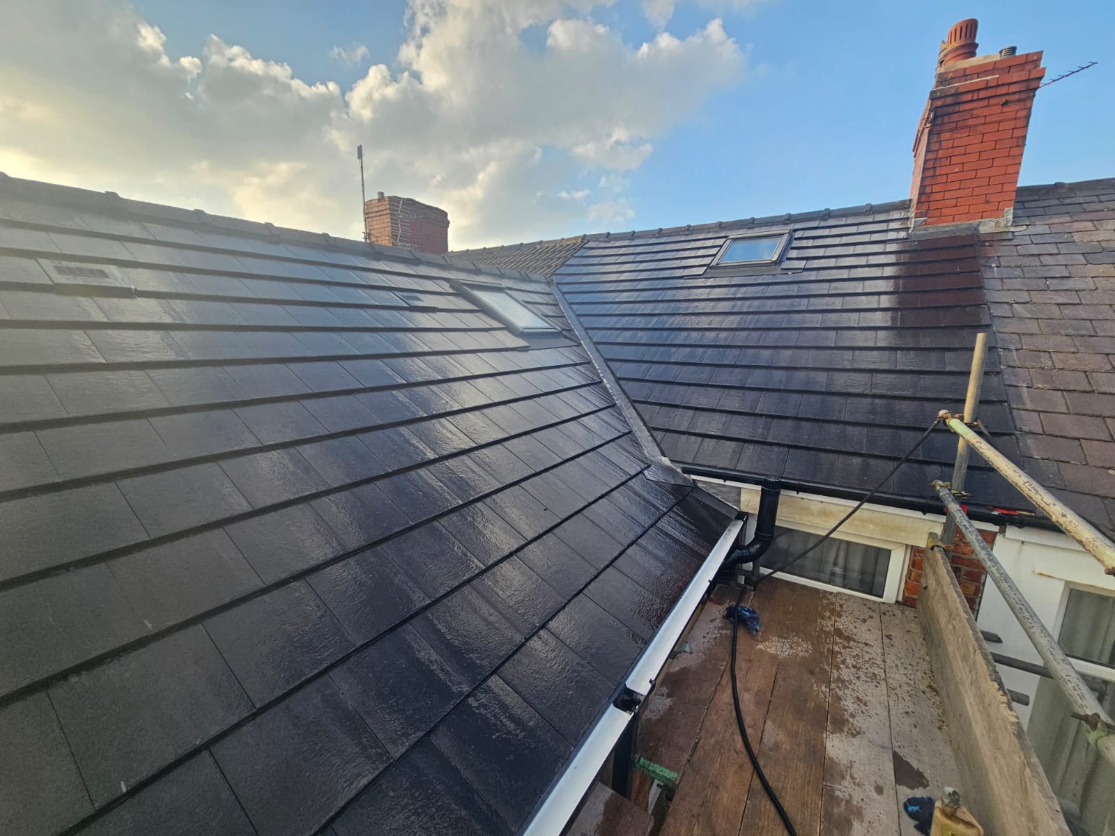 Full pitched roof re-tile with new skylights and leadwork valleys