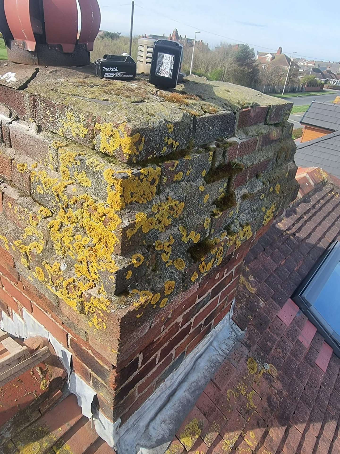 Chimney before restoration — weathered brickwork & failed flaunching